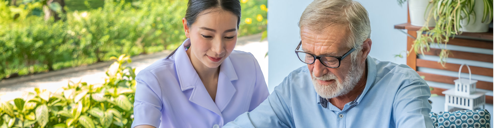 nurse assisting elderly man